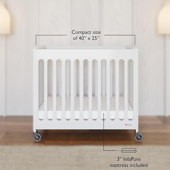 Foundations Boutique Folding Mini Baby Crib - Compact, Portable, Wooden Hotel Crib, Foldable Compact Cribs for Baby & Toddlers - Includes 3" Foam Mattress - White