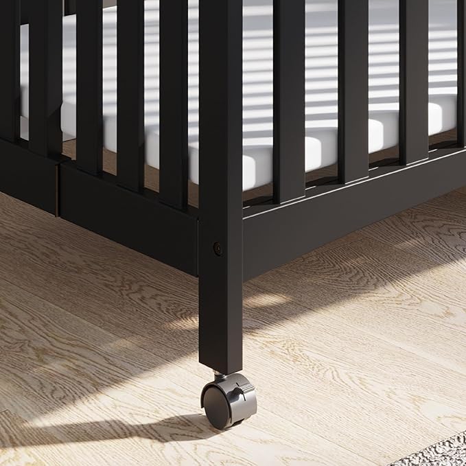 Child Craft London Mini Compact Folding Portable Crib with 2” Crib Mattress and 2 Easy Roll Locking Wheels, Durable Pine Wood Construction (Ebony Black)